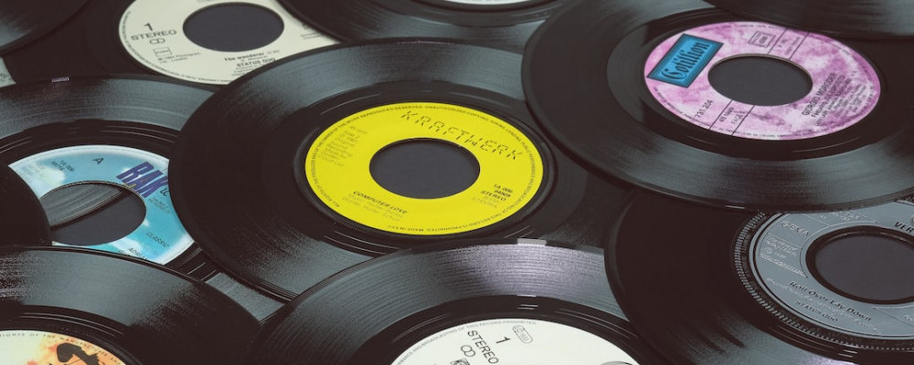 a pile of US style 7 inch singles with a large spindle hole